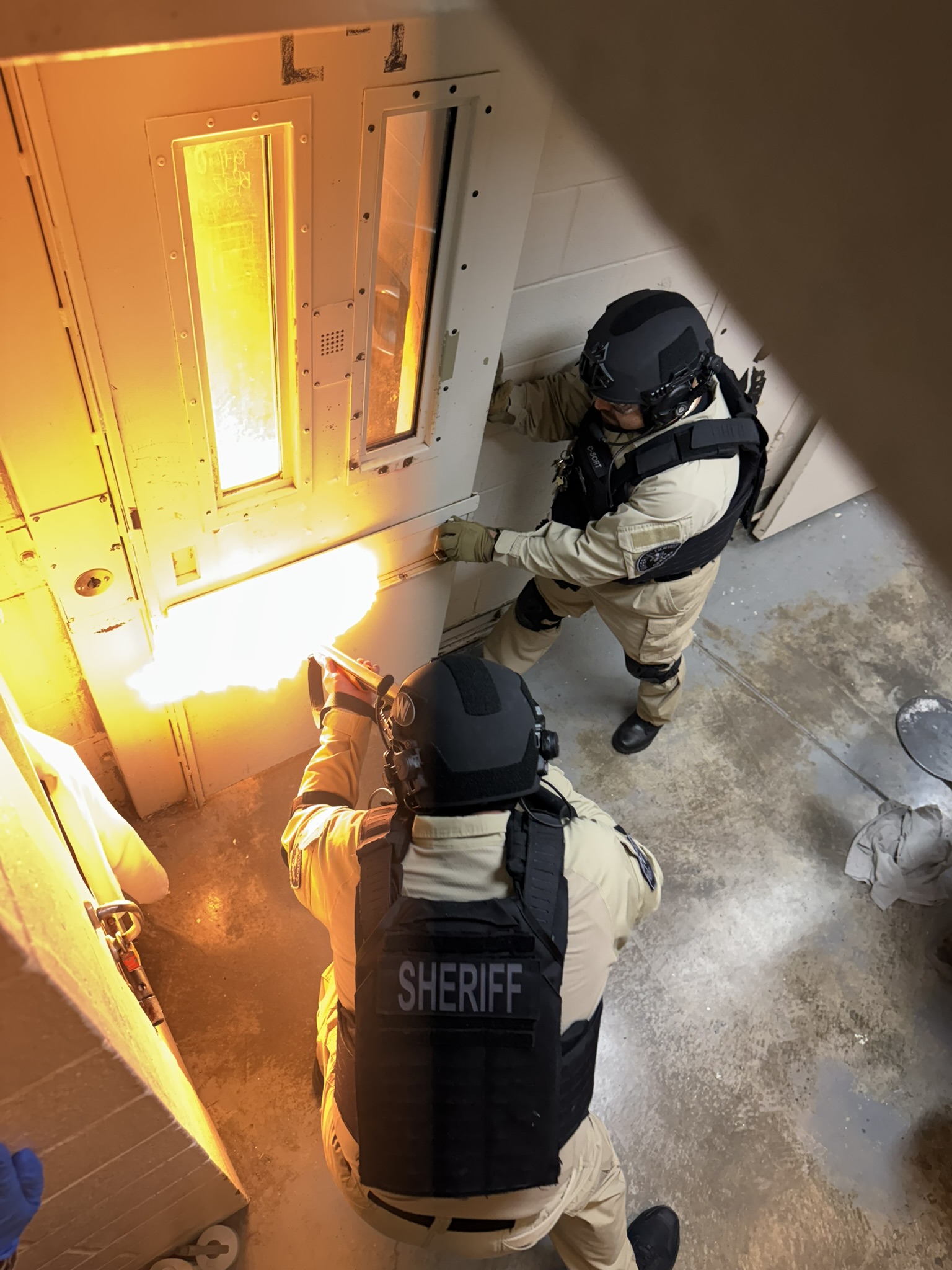 C-SORT team members in tactical helmets preparing to enter a facility